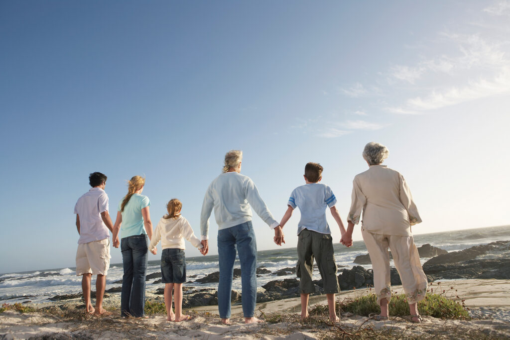 family standing in a line and holding hands