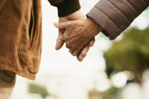 senior couple holding hands as they go for a walk
