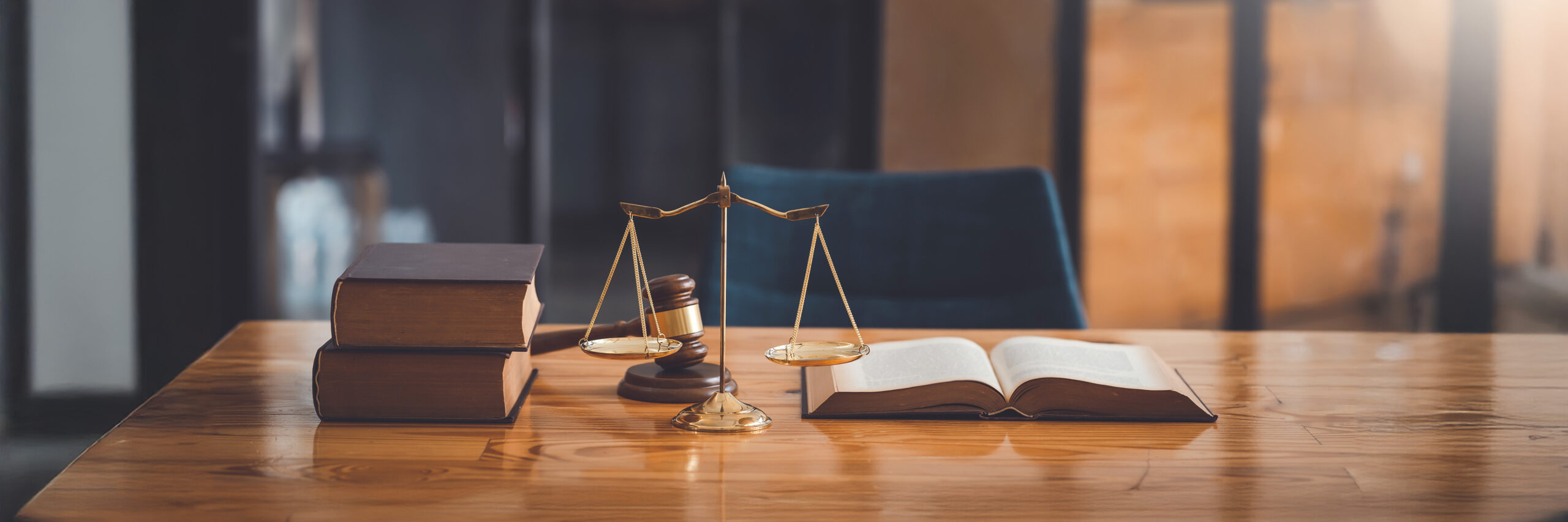 scales and legal books sitting on a wood desk