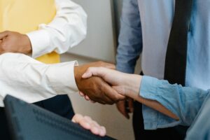 a group of lawyers standing together and shaking hands
